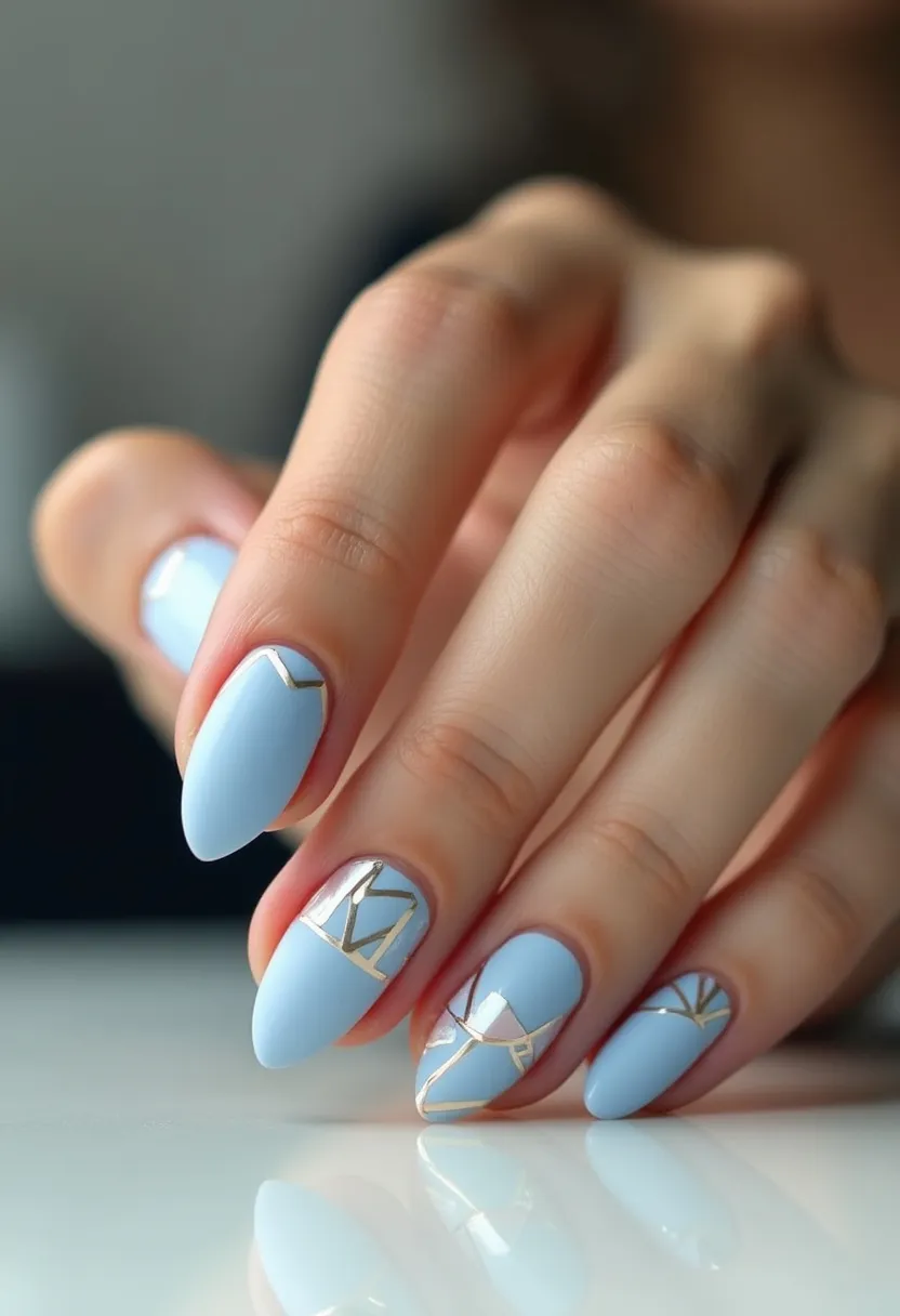 The nail design features an elegant almond shape, providing a sophisticated and elongated appearance to the nails. The primary color in the palette is a soft, pastel blue, contributing to a serene and calming aesthetic. Intricate geometric patterns, highlighted by gold accents, adorn some of the nails, adding a touch of luxury and intricacy. These geometric lines and shapes create a modern art-deco effect. The nails appear to be treated with a gel polish, evident from the smooth and glossy finish that enhances the design's durability and sheen. The color choice and sleek lines suggest a versatile design suitable for any season, effortlessly complementing both casual and formal occasions with a hint of contemporary elegance.