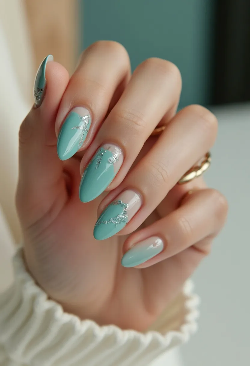 This nail design features a soothing pastel green color palette, with the color applied in an almond shape that enhances the elegant appearance of the nails. The nails are decorated with intricate silver foil accents, which add a touch of glamour and sophistication. The design employs a gel treatment, giving the nails a glossy and smooth finish. The combination of the pastel green and silver metallic foil creates a visually striking contrast, making the design suitable for special occasions or festive events. The overall aesthetic of the nails exudes a fresh, contemporary vibe, perfect for a spring or summer theme.