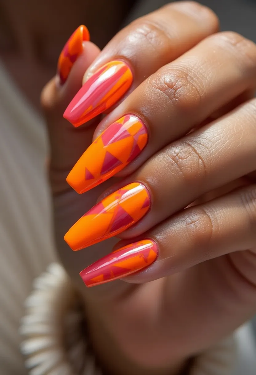 This nail design features a vibrant color palette predominantly consisting of bright orange and pink shades, forming a bold and eye-catching look. The nails are long and shaped into a modern coffin or ballerina style, which adds to the chic and trendy appearance. Intricate patterns of geometric shapes are artfully arranged on each nail, combining pink triangles with the orange background to create a striking contrast and visual interest. The design is likely achieved using gel nail treatment, given the glossy finish and the detailed, precise nature of the patterns. This fun and lively design exudes a summer vibe, making it suitable for warm weather and festive occasions.