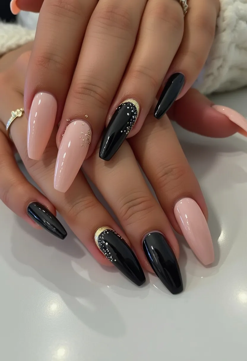 The  nail  design  features  a  combination  of  black  and  pink  nails,  with  black  nails  having  gold  dots  on  them.  The  nails  are  shaped  in  a  long,  pointed  style.  The  nail  treatment  appears  to  be  acrylic  nails,  which  are  known  for  their  durability  and  ability  to  hold  intricate  designs.  The  gold  dots  on  the  black  nails  add  a  touch  of  elegance  and  sophistication  to  the  overall  look.