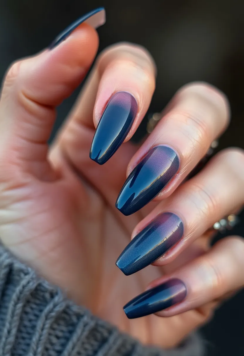 The nail design features a sophisticated and elegant ombre effect transitioning from a rich, dark navy blue at the tips to a soft mauve near the cuticle. The nails are long and tapered, shaped into a sharp almond style that enhances the overall aesthetic of the design. The finish appears to be smooth and glossy, indicative of a gel or shellac treatment, which provides a durable, high-shine effect. This gradient color palette embodies a stylish and modern look, making it suited for various occasions, including formal events or evening outings. The seamless blend of colors and the flawless execution of the gradient creates a mesmerizing effect, adding a touch of sophistication and elegance to the entire look.