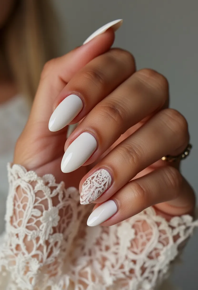 The nail design features a chic and elegant style, perfect for a special occasion such as a wedding. The nails are shaped into a classic almond form, providing a sophisticated and elongated appearance. The color palette includes a soft, creamy white base that exudes simplicity and elegance. An intricate lace-like pattern decorates the ring finger, adding a touch of delicate intricacy and feminine charm. This detailed lace pattern is likely created with a stamping technique or hand-painting and complements the overall elegant theme. The nails appear to have a smooth and glossy finish, suggesting the use of either gel or shellac treatment, which provides both durability and a high-shine look. The design, with its refined details and subtle color choices, suits a romantic and elegant theme, making it ideal for bridal or other formal events.