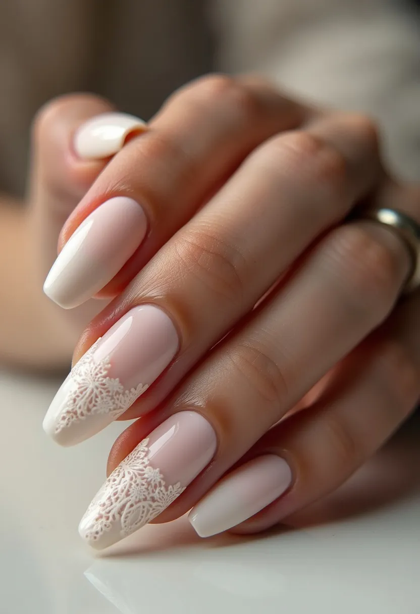 The nail design features a soft, elegant palette dominated by light pink and white hues, creating a sophisticated and delicate look. The nails are shaped in a mildly tapered, almond form, providing a graceful and elongated appearance to the fingers. The primary decoration is a beautifully intricate white lace pattern applied to the tips of some nails, which contrasts subtly against the pink base, giving a refined and detailed finish. This nail art appears to be executed using gel treatment, ensuring a glossy and smooth surface. The overall design evokes a bridal or special occasion theme, ideal for weddings or formal events, with its meticulous craftsmanship and feminine charm.