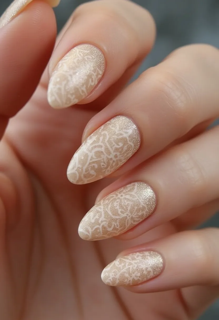 The nail design showcases a sophisticated and elegant aesthetic, featuring an almond shape that is both trendy and timeless. The color palette consists of a subtle, shimmery champagne base that exudes a soft, luxurious feel. Intricate white lace-like patterns overlay the champagne base, adding a delicate and feminine touch to the overall design. This intricate detailing suggests a careful and skilled application, likely achieved using gel or acrylic nail treatments known for their durability and ability to hold fine designs. The combination of the color scheme and intricate lace patterns makes this design ideal for special occasions such as weddings or formal events, evoking a sense of romance and sophistication.