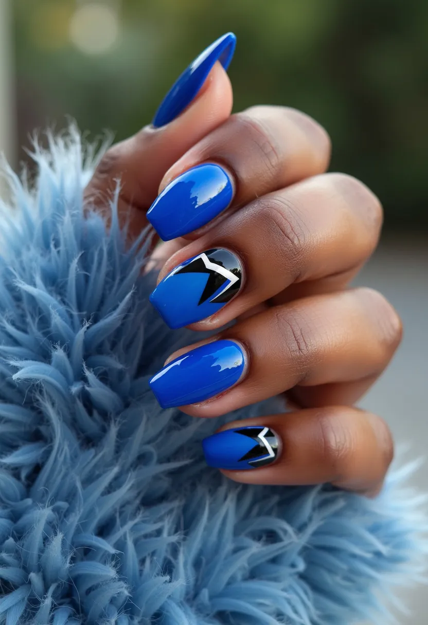 The nail design features a striking blue color palette, with a high-gloss finish suggesting they are likely gel nails. The nails are medium-length and shaped into a squared-off form. Two of the nails, specifically the ring finger and the pinky, incorporate intricate geometric patterns in black and silver, creating a bold contrast to the solid blue nails. These accents add a modern and edgy touch to the overall design. The combination of colors and the futuristic design elements could be suitable for a trendy, fashionable look that is perfect for a stylish winter or nighttime occasion.