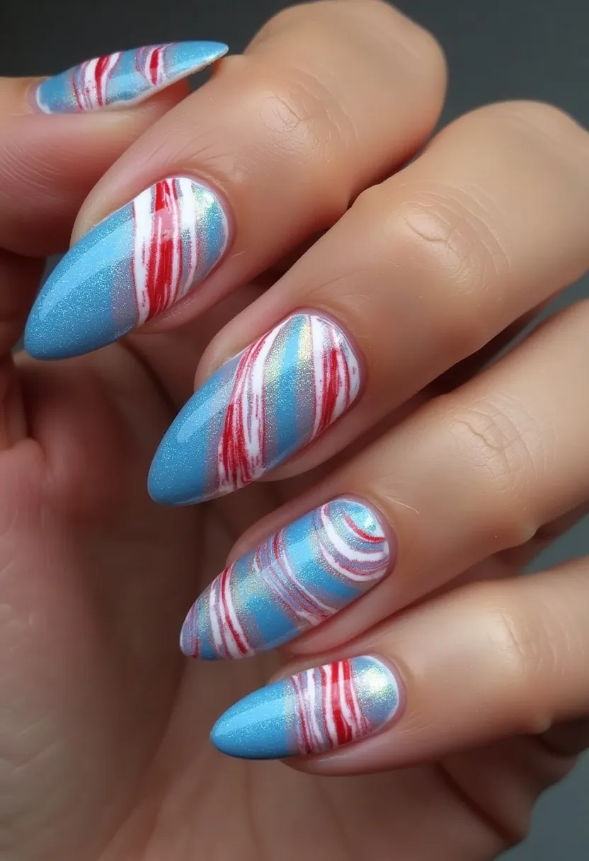 This nail design features a striking color palette consisting primarily of shimmering blue, with accents of red and white marbling creating an eye-catching pattern. The nails are shaped in a pointed almond style, providing a sleek and elegant appearance. The intricate marbling pattern, with its swirls of red and white over the blue base, adds sophistication and complexity to the design, suggesting a professional gel or shellac treatment to achieve the smooth and glossy finish. This design exudes a wintery or festive vibe, making it perfect for the holiday season or special events where a standout manicure is desired.