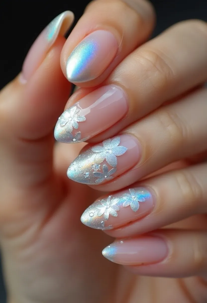 The nail design showcases an exquisite blend of colors and elegant decorations. The color palette features a gradient of iridescent silver and soft pink, creating a shimmering effect that captures light beautifully. The nails are shaped in a sophisticated almond form, providing a stylish and feminine look. Intricate floral patterns adorn the tips of the nails, intricately designed with a combination of metallic silver and white, adding a romantic and delicate touch to the overall appearance. The nail treatment appears to be gel polish, as suggested by the glossy finish and the smooth, durable surface of the nails. This design evokes a sense of luxury and would be fitting for special occasions such as weddings, proms, or holiday gatherings, enhancing the charm and elegance of any outfit.