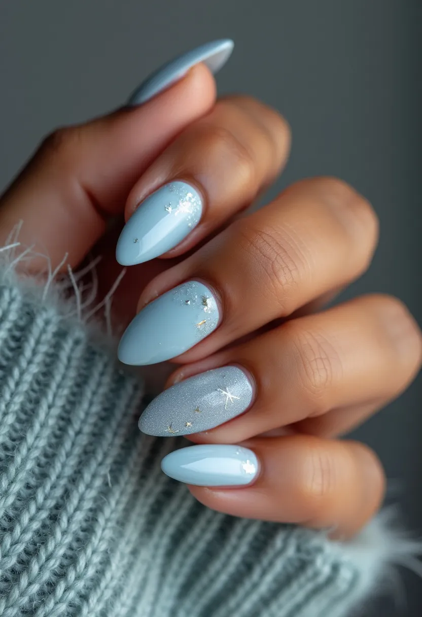 The nail design features an elegant, winter-themed aesthetic with a cohesive color palette of soft pastel blue and metallic silver. The nails are shaped in a medium-length almond style, lending a sophisticated and feminine appearance. Each nail is coated with a gel treatment for a glossy and long-lasting finish. Intricate decorations include delicate white and silver snowflake patterns and tiny star-shaped glitter accents, enhancing the seasonal theme. The combination of matte and shimmering textures, along with the intricate designs, creates a festive yet subtle look suitable for the winter season and special occasions such as holiday gatherings.