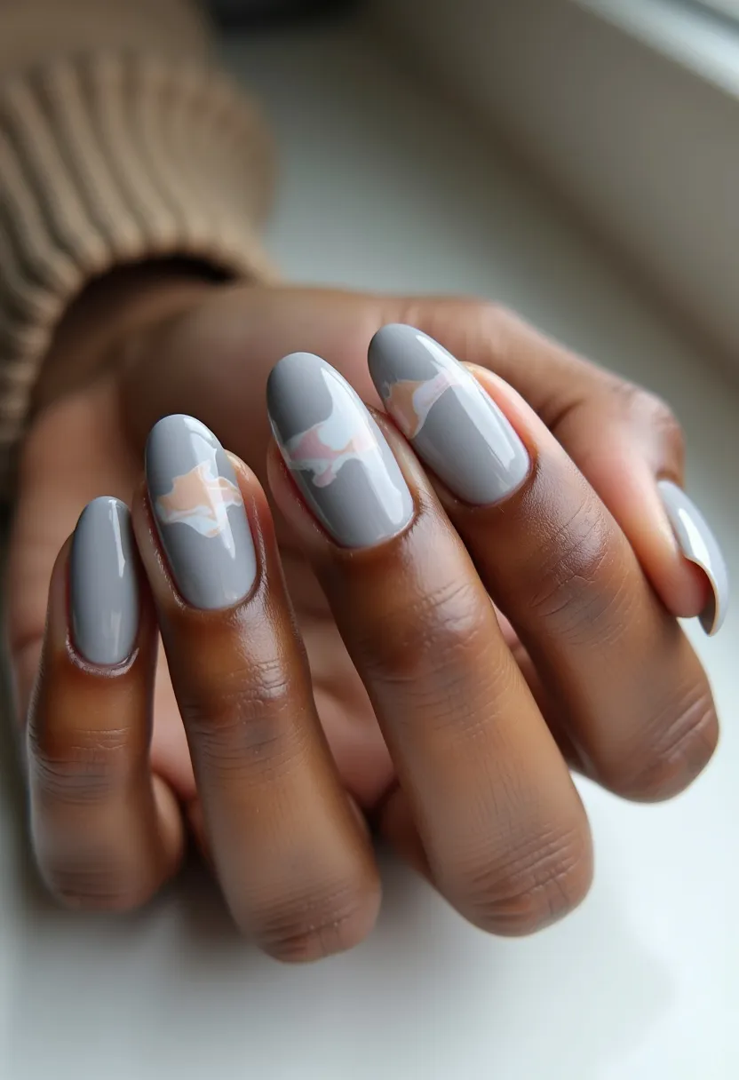 The featured nail design showcases medium-length, oval-shaped nails with a sophisticated color palette dominated by a soft grey base. Over this base, there are delicate, swirling patterns in pastel pink and beige, adding an artistic and elegant flair. The nails appear to be treated with a glossy finish, likely indicative of gel polish, providing a sleek and durable look. This design could suit various seasons due to its neutral tones, but the pastel accents also give it a slight leaning towards spring or summer. The intricate, wavy pattern adds a unique detail, making the nails refined yet understated, suitable for both casual and formal occasions.