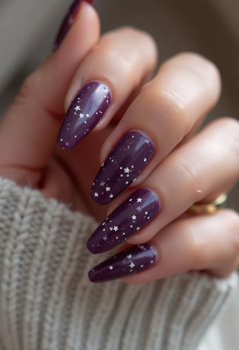 The nail design features a deep plum purple color as the primary palette, creating a rich and sophisticated look. The nails are medium to long in length and shaped in a tapered almond form, enhancing the elegance and elongation of the fingers. Intricate white star and dot patterns are scattered across the nails, adding a whimsical and celestial theme that could be perfect for a night out or special event. The glossy finish suggests a gel or shellac treatment, providing a polished and durable appearance. This design is versatile, suitable for various occasions but has a particular resonance with evening events or a winter season theme due to its dark, starry night aesthetic.