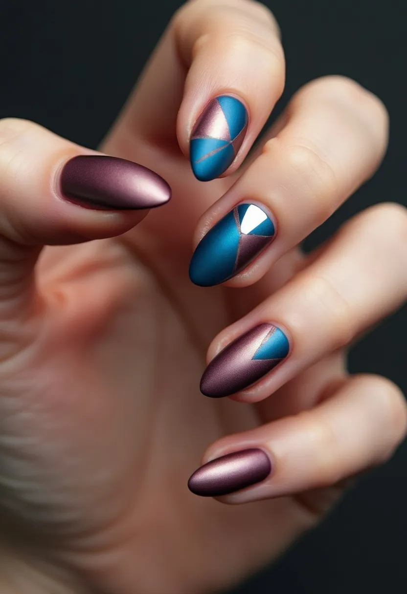 The nail design features a sophisticated color palette of matte finishes, primarily incorporating a deep plum and a rich teal. The nails are almond-shaped, providing a classic and elegant appearance. Intricate geometric patterns adorn several of the nails, including a combination of triangular shapes and metallic accents that introduce a striking contrast. The design appears to be achieved with a combination of gel and possibly metallic foil, offering both durability and a sleek finish. The overall look is contemporary yet versatile, ideal for both seasonal transitions, such as autumn, and special occasions, where a touch of modern sophistication is desirable.