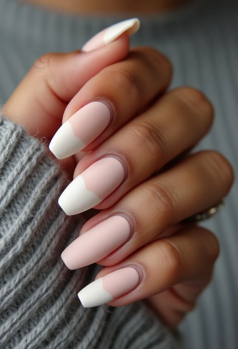 The nail design features a minimalist yet elegant color palette with a neutral pink base and crisp white accents. The nails are shaped into a long, tapered square style, providing a sophisticated and modern look. The design incorporates a distinctive French tip twist, where the white tips have an irregular, wave-like pattern, adding a unique touch to the classic style. The nails appear to have a matte finish, which suggests a possible treatment of gel polish with a matte top coat. The simplicity and elegance of the design could make it suitable for various occasions, including weddings, formal events, or as a chic everyday look. The muted tones and geometric patterns are subtle, making this design versatile for different seasonal themes, particularly fitting for spring or summer with its fresh and clean aesthetic.