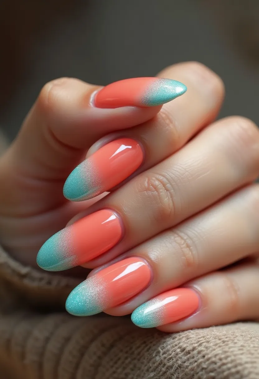 The nail design features a vibrant and eye-catching color palette with a gradient effect, blending a coral base into a teal tip. The nails are shaped in an almond style, creating an elegant and elongated look. The intricate pattern involves a smooth transition from the coral color at the cuticle to the shimmery teal at the tips, giving a sophisticated ombre effect. This design appears to use a gel treatment, evident from the high-gloss finish and vibrant, long-lasting colors. The combination of coral and teal, along with the shimmery effect, suggests a spring or summer theme, making it suitable for seasonal or casual special occasions.