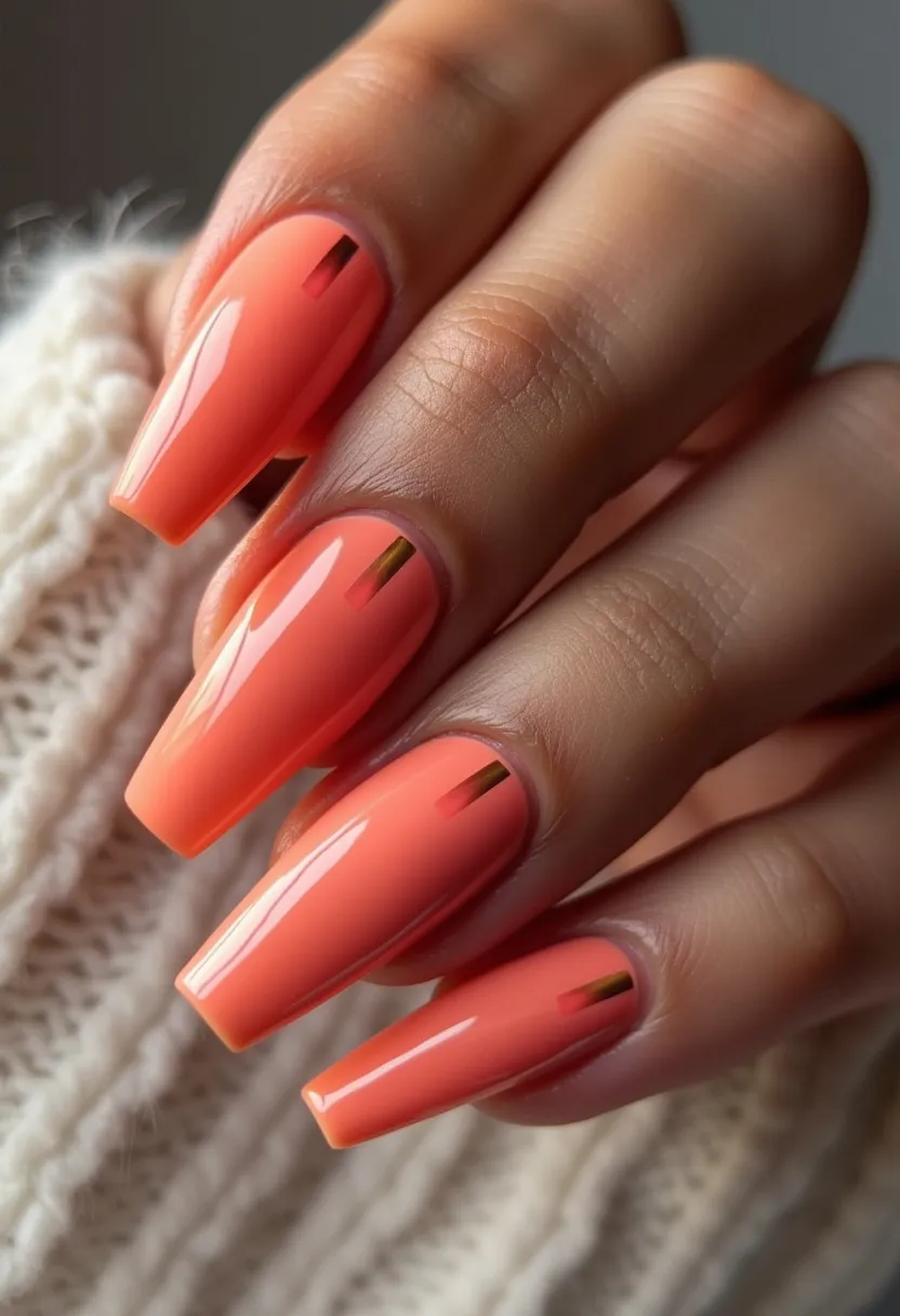 The nail design features a striking color palette of vibrant orange with a smooth and glossy finish, suggesting the use of gel treatment for a sleek and durable look. The nails are shaped into long, elegant coffin shapes, accentuating the sophisticated appearance. Each nail is adorned with a simple yet eye-catching vertical gold strip near the cuticle, adding a touch of metallic elegance to the overall design. The orange shade, combined with the golden accents, hints at a warm and playful theme, making this design appropriate for summer or festive occasions. The glossy finish further enhances the brightness and freshness of the look, showcasing a meticulous and polished manicure.