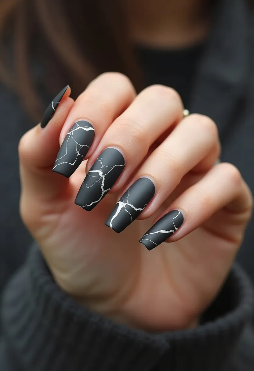 The nail design features a matte black color palette adorned with a fine white marble pattern, creating an elegant and sophisticated look. The nails are shaped into a long, coffin style which complements the intricate marbling effect. This particular design appears to be achieved using gel treatment, giving it a smooth and durable finish. The contrast between the dark base and the delicate white veins mimics natural marble stone, making this an ideal design for autumn or winter seasons, as well as special occasions like formal events or evening outings. The unique details in the veins add a touch of luxury and refinement to the overall aesthetic.