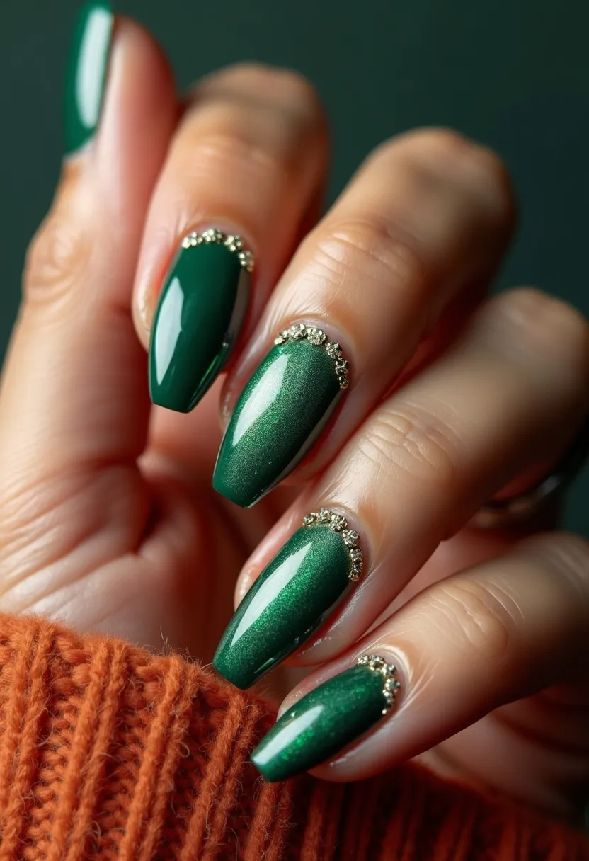 The nail design features a rich, forest green color palette, encapsulating an elegant and somewhat festive theme. The nails are almond-shaped, promoting a sophisticated and elongating aesthetic for the fingers. Each nail is adorned with small, intricate gold rhinestones near the cuticles, adding a touch of luxury and sparkle, ideal for festive or formal occasions. The nails appear to have a glossy finish, suggesting a gel nail treatment that offers a sleek, long-lasting shine. This design integrates a subtle gradient effect on a couple of the nails, enhancing the depth and visual interest of the overall look. The combination of deep green and gold embellishments creates a glamorous yet classic appearance, perfect for the winter season or holiday events.