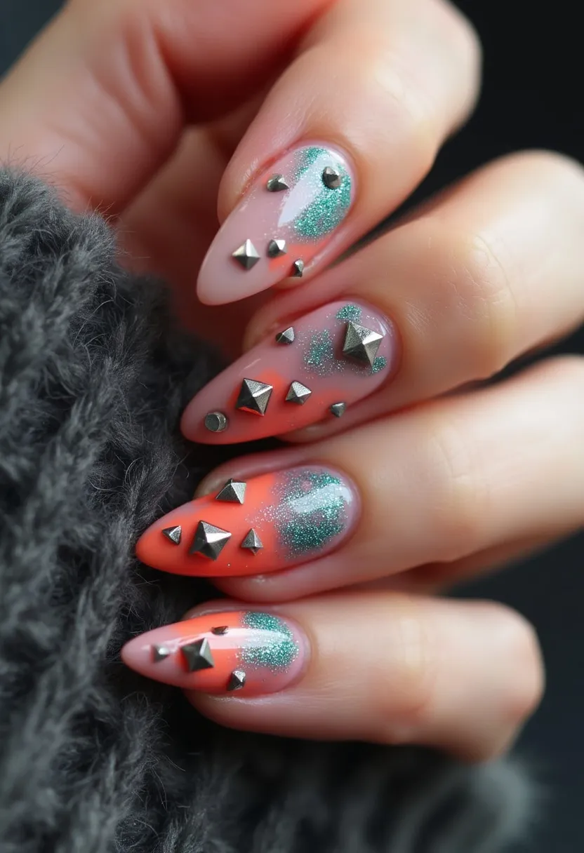 The nail design features a striking combination of colors and decorations. The nails are almond-shaped and are treated with a glossy finish that suggests either gel or shellac. The color palette prominently includes a gradient of coral orange blending into nude at the base, coupled with shimmery green accents that add a touch of sparkle. Intricate decorations include metallic studs and pyramid-shaped embellishments that vary in size, strategically placed across the nails to create a visually appealing and edgy pattern. This bold and vibrant design appears to be well-suited for festive occasions or a stylish night out, offering a blend of glamour and rebellion.