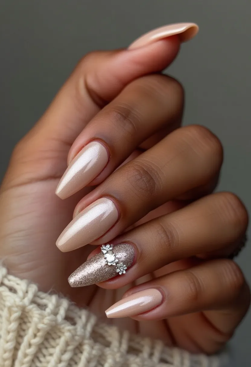 This nail design showcases a sophisticated and elegant style, featuring long, almond-shaped nails. The primary color palette consists of a pearlescent, shimmery nude hue that covers most of the nails, creating a subtle yet glamorous look. The accent nail stands out with a glittery gold finish, adorned with detailed 3D floral decorations, adding a touch of artistry and texture to the overall design. The nails appear to have a smooth, glossy finish, suggesting the use of gel or shellac treatment for durability and shine. This design could be suitable for special occasions like weddings or formal events, reflecting a timeless and refined aesthetic.