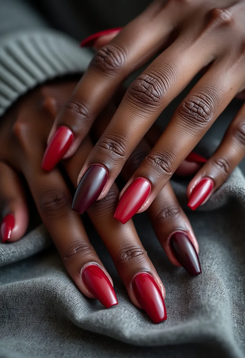 The nail design features elongated, coffin-shaped nails painted in a rich color palette of deep, dark reds and bright reds. The nails showcase a glossy finish, indicative of a gel treatment, providing a sleek and shiny appearance. The ring fingers on both hands display a gradient or ombre effect, blending from a vivid red to a darker, almost black shade, adding an element of sophistication and visual interest. The rest of the nails are painted uniformly in a consistent red hue. This design exudes a classic and elegant vibe, suitable for a formal or festive occasion like the holiday season.