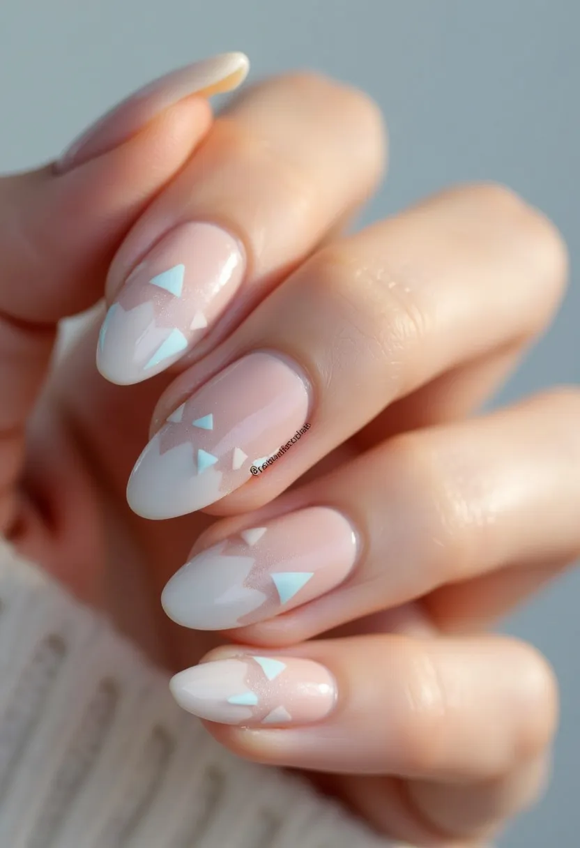 This nail design showcases a soft pastel color palette of pink and white, accented with subtle light blue triangular patterns. The nails are almond-shaped, which complements the delicate design elements, creating an elegant and feminine appearance. The intricate triangular decorations on a few nails add a geometric flair to the overall look. The high-gloss finish suggests a gel or shellac treatment, ensuring durability and a polished shine. The pastel colors and patterns make this design suitable for a spring or summer theme, and it could be perfect for special occasions such as weddings or garden parties where a sophisticated yet understated look is desired.