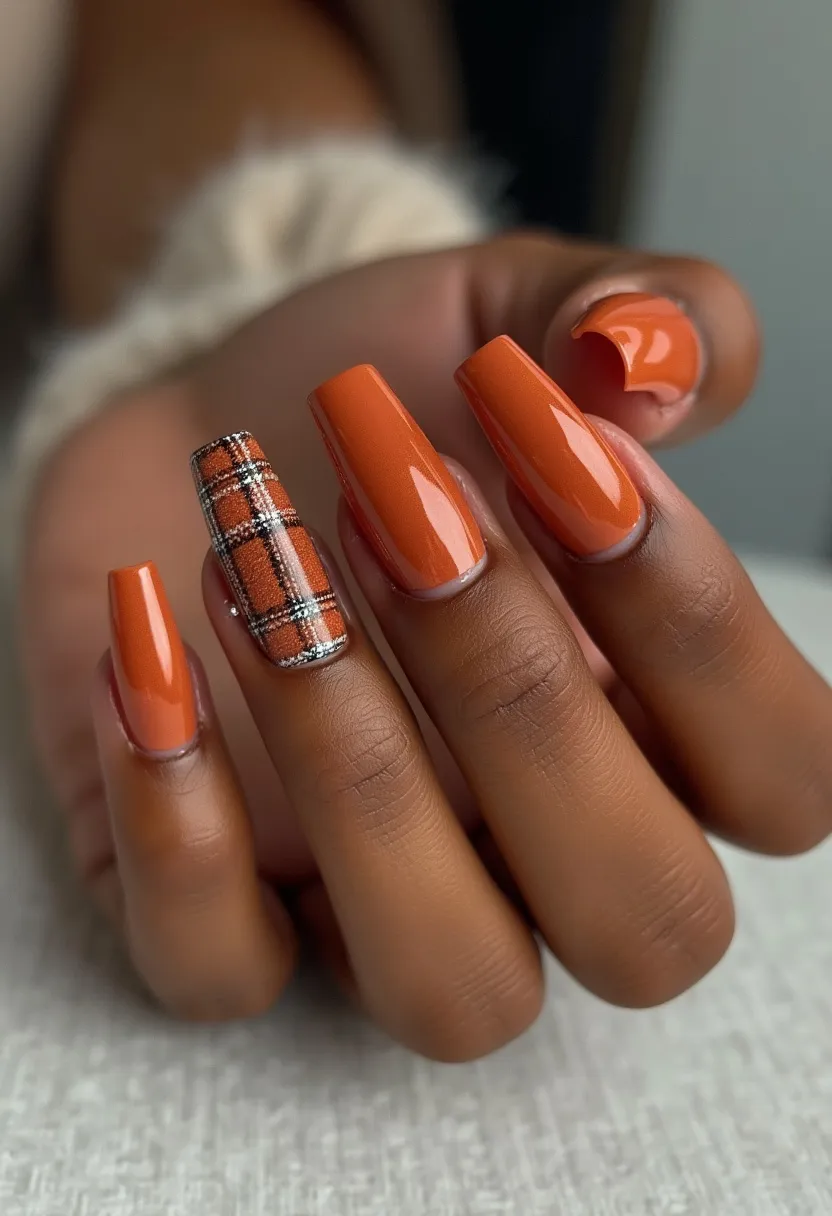 The  nail  design  features  a  combination  of  orange  and  red  nail  polish,  with  a  checkered  pattern  on  the  nails.  The  nails  are  shaped  in  a  square  shape,  and  the  nail  treatment  appears  to  be  a  gel  or  acrylic  application.  The  unique  design  and  color  palette  create  a  bold  and  eye-catching  look,  suitable  for  special  occasions  or  seasonal  themes.