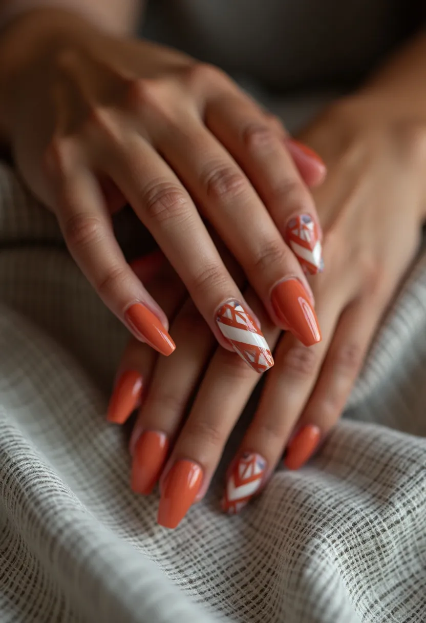 The nail design features a vivid orange color palette paired with intricate white geometric patterns and stripes on certain nails. The nails are medium to long in length and shaped into a tapered square, giving them a modern and elegant appearance. The design includes a mix of solid orange nails and accent nails, which showcase a detailed geometric pattern composed of triangles and lines. The precise finish and glossy look suggest a gel or shellac treatment, adding both durability and shine. The vibrant orange combined with the intricate design evokes a seasonal autumn theme, perfect for fall festivities or special occasions where a bold, stylish appearance is desired.