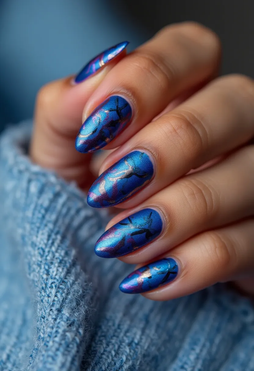 The nail design features a striking and vibrant color palette dominated by a rich metallic blue hue, complemented with hints of shimmering purple and pink undertones, creating a multi-dimensional effect. The nails are shaped in an elegant almond form, elongating the fingers and providing a sophisticated appearance. Intricate black patterns resembling delicate tree branches or abstract silhouettes grace the surface, adding an artistic touch to the overall design. This appearance suggests that the nails are likely treated with a gel or nail polish to achieve the glossy and smooth finish typical of high-quality manicures. The combination of deep blue, metallic accents, and intricate black detailing is reminiscent of an autumn or winter theme, making them suitable for the colder seasons or festive occasions.