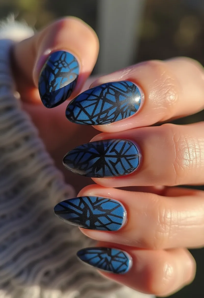 The nail design features almond-shaped nails, expertly painted with a gel treatment that gives a glossy and durable finish. The color palette showcases a striking combination of blue as the base color, adorned with intricate black geometric patterns that create a stained glass window effect. The design is detailed and consistent across each nail, suggesting a methodical approach using possibly stencil or stamp techniques to achieve symmetry. The choice of colors and patterns could be suitable for a variety of occasions, ranging from casual to semi-formal events, and would complement seasonal transitions into autumn or winter with its cool hues and sophisticated artistry.