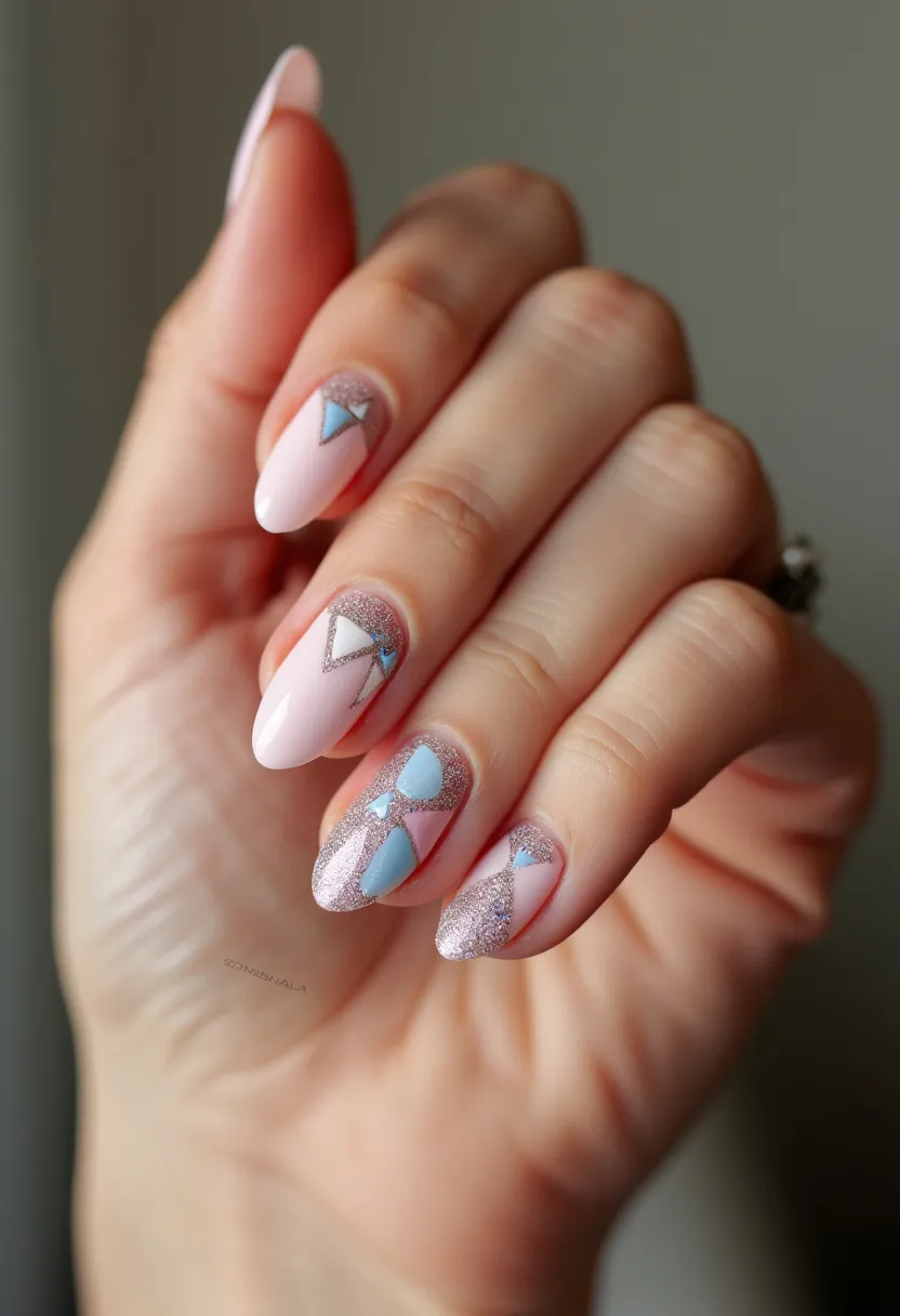 This nail design features an elegant and modern look with a soft pastel color palette that includes light pink and powder blue shades, complemented with fine silver glitter accents. The nails are almond-shaped, offering a timeless and flattering silhouette. Each nail displays intricate geometric patterns, including triangles and abstract shapes, subtly outlined to enhance the visual appeal. The use of glitter adds a touch of glamour, possibly achieved through a gel or shellac treatment, ensuring a smooth and shiny finish. This design, with its delicate colors and sparkling details, could be perfect for a spring or summer season, as well as for special occasions such as weddings or formal events where a sophisticated yet playful aesthetic is desired.