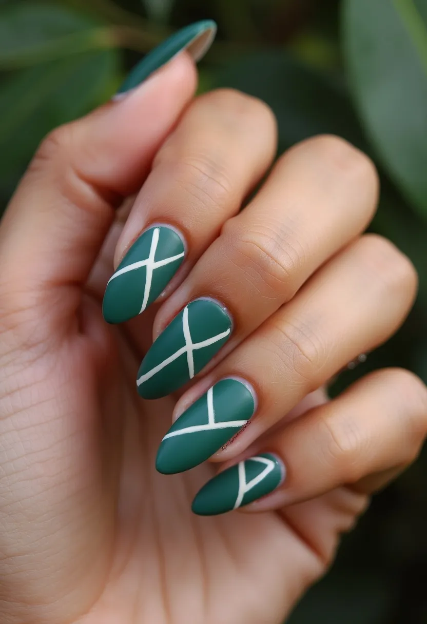 The nail design features a sophisticated and elegant palette, predominantly in a matte teal color. The nails are shaped into a sleek almond form, emphasizing a stylish and trendy look. Each nail is adorned with delicate white crisscross lines, adding an intricate geometric pattern that subtly enhances the overall design. This suggests a gel treatment, providing a smooth and lasting finish. The design's simplicity combined with the rich color makes it versatile, suitable for various seasons and occasions, from casual to formal settings. There are no additional embellishments, keeping the look clean and understated.