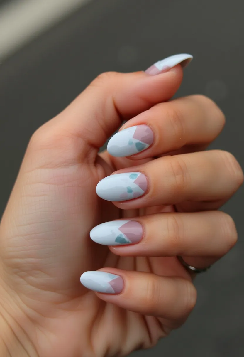 The nail design features an elegant and contemporary look with a minimalistic color palette consisting of soft white, pale pink, and subtle blue accents. The nails are medium to long in length and are shaped in a smooth almond oval. For the pattern, there's a triangular geometric overlay near the cuticle, highlighting a base of neutral pink with white tips adorned with delicate blue dots. This intricate yet understated design suggests that the nails may have undergone a gel treatment to achieve a glossy and durable finish. The color choice and design suit various occasions, offering a sophisticated and fresh appearance that could work well for both everyday wear and special events.