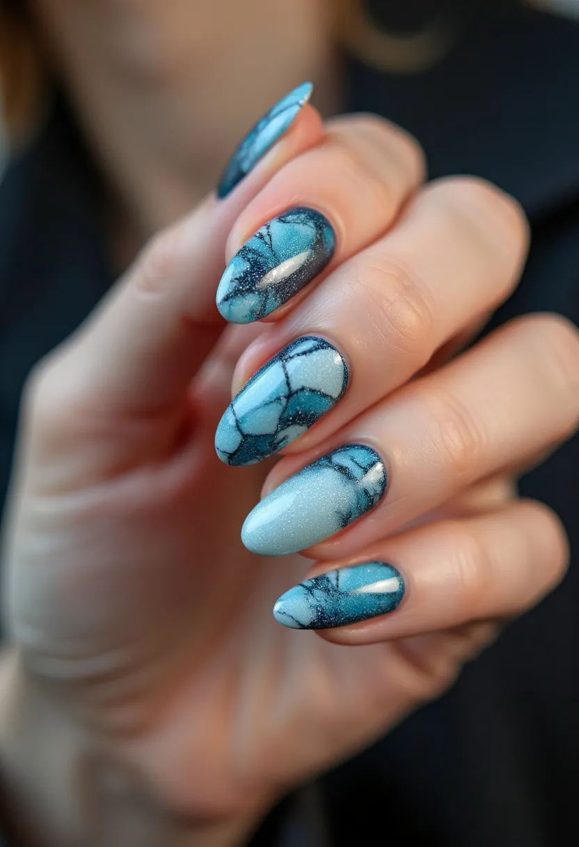 The nail design features a striking blue color palette, blending shades of turquoise and azure with dark, intricate marbling patterns that mimic natural stone textures. The nails are shaped into an elegant almond form, providing a stylish and elongated appearance. Likely achieved through a gel treatment, the finish is smooth and glossy with a slight shimmer, adding a sophisticated and high-end look to the design. There are fine black lines running through the marbling, creating a high-contrast effect that enhances visual interest. This design could be fitting for both winter and spring seasons, invoking imagery of icy landscapes or clear skies, making it versatile for various occasions and gatherings.