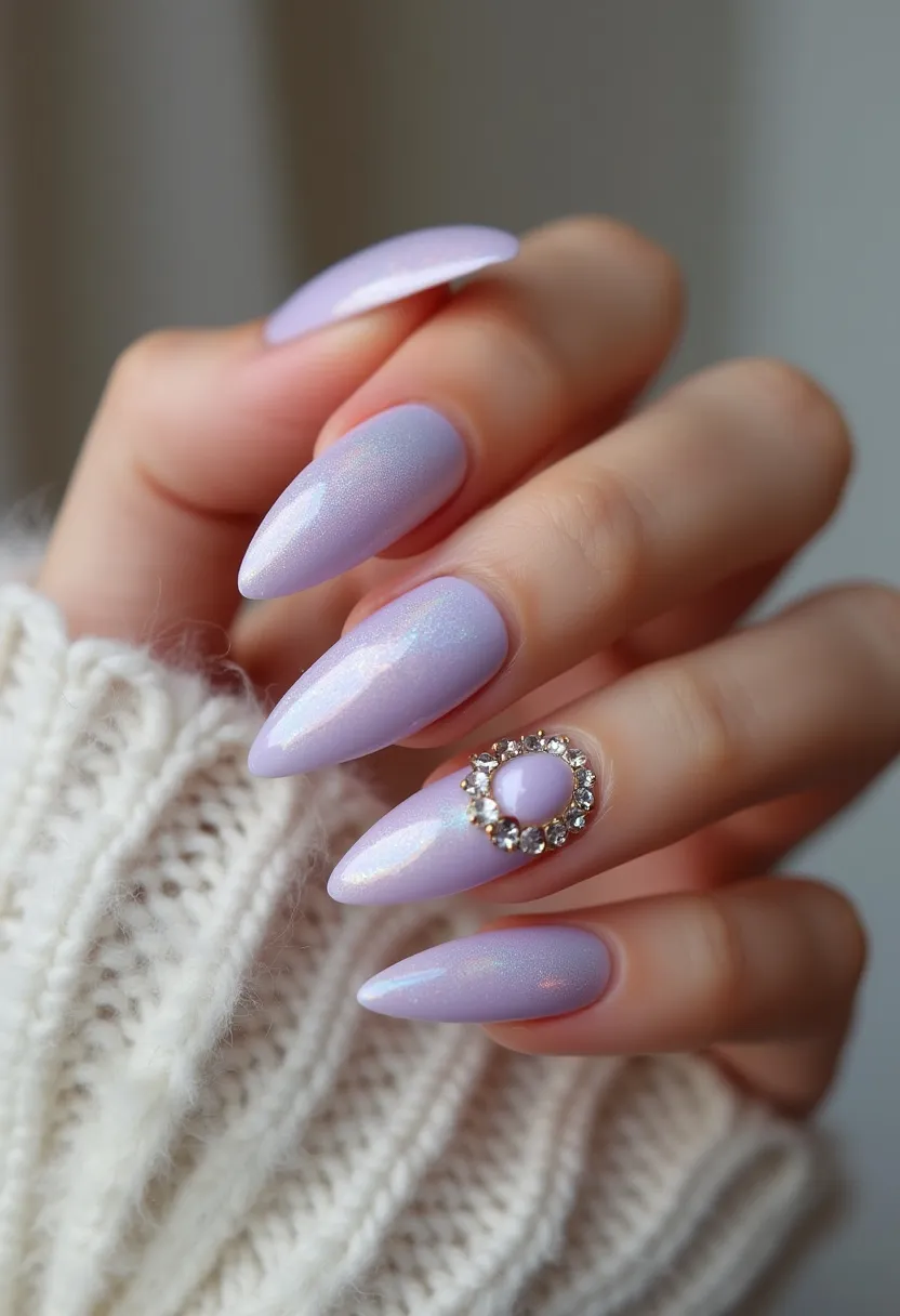 The nail design features a soft, lilac color palette with a subtle shimmer, giving the nails a delicate and ethereal appearance. The nails are almond-shaped, complementing the elegant color choice. One of the nails is adorned with an intricate decoration: a raised lilac gem encircled by small, sparkling rhinestones, creating a striking focal point. The nails appear to have a glossy finish, indicative of a gel nail treatment that enhances the durability and shine of the design. This manicure has a refined and sophisticated look, making it suitable for special occasions or as an elegant everyday accessory.