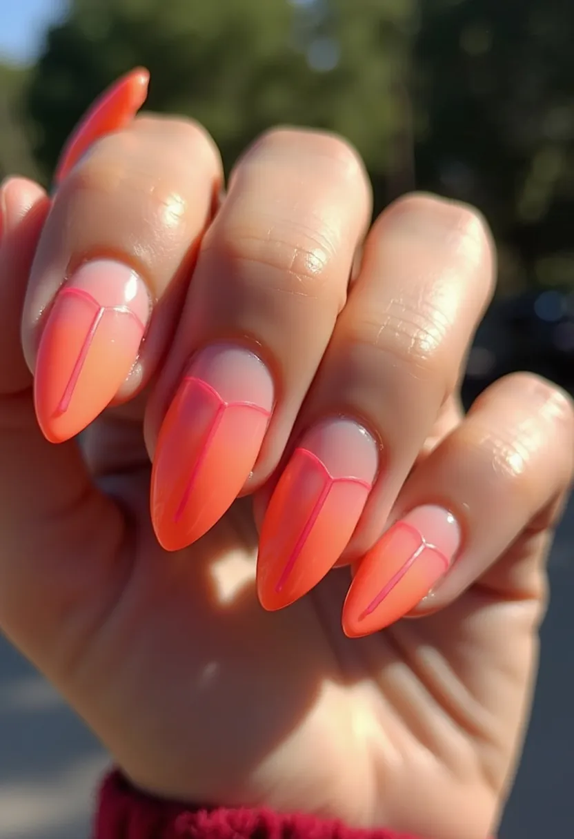 The nail design features a striking, vibrant color palette of orange and pink with a gradient or ombre effect seamlessly blending from one color to the other. The nails are shaped into a pointed almond form, providing an elegant and edgy look. Each nail is decorated with an intricate pattern consisting of a vertical line down the center and curved lines near the base, drawn in a contrasting pink hue that enhances the overall design. The treatment appears to be a gel manicure, given the glossy and smooth finish. The bright, cheerful colors and the playful design suggest a summery or tropical theme, making it particularly suitable for warm weather or festive occasions. The overall look is both bold and sophisticated, perfect for someone looking to make a statement.