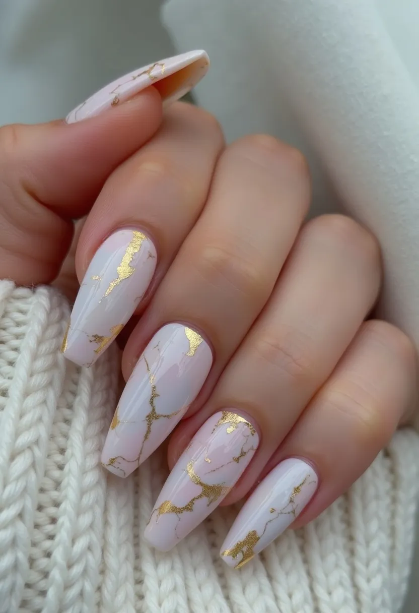 The nail design showcases a beautiful and sophisticated look characterized by a long, coffin shape. The nails are finished with a soft, pastel pink base color, accented with elegant gold foil detailing that mimics the appearance of marble veins. The combination of the subtle pink and striking gold creates a luxurious and refined aesthetic. This design likely uses gel or acrylic treatments to achieve the smooth and polished surface. The intricate gold patterns add a touch of artistry and make the nails suitable for special occasions or upscale events. The overall theme exudes elegance, making it a timeless choice for those looking for a chic and refined nail style.