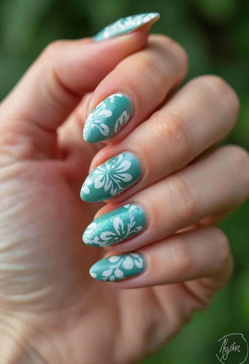 This nail design features a turquoise color palette with a shimmering finish, which appears to be a gel treatment due to its gloss and durability. The nails are shaped into a rounded almond style, adding an elegant and elongated look to the fingers. Each nail showcases a white floral pattern, intricately painted, enhancing the aesthetic with a delicate touch. The floral design evokes a summery and fresh theme, making it suitable for warm-weather occasions or special events that call for a touch of nature-inspired elegance.