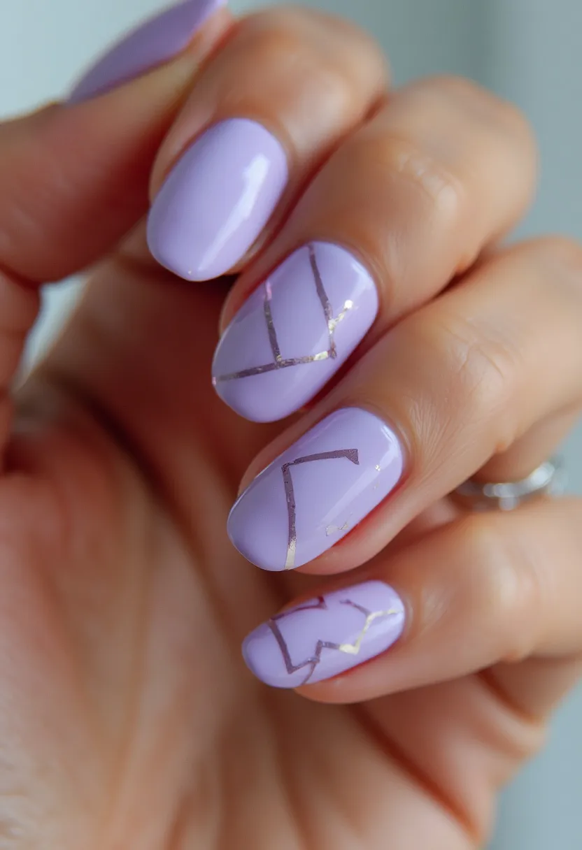 The  nail  design  features  purple  nails  with  gold  accents,  giving  them  a  unique  and  elegant  appearance.  The  nails  are  shaped  in  a  short,  rounded  style,  and  the  nail  color  palette  is  a  combination  of  purple  and  gold.  The  nail  treatment  appears  to  be  a  gel  or  acrylic,  as  it  is  able  to  hold  the  intricate  patterns  and  decorations.  The  design showcases  a  creative  and  stylish  approach  to  nail  art.