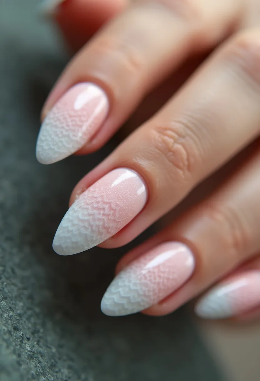 The nail design features an almond shape with a sophisticated, elegant look. The color palette is soft and subtle, incorporating a delicate gradient of light pink transitioning into white towards the tips. The nails are adorned with intricate chevron patterns that add texture and visual interest, blending seamlessly from the pink base into the white. Given the glossy, smooth finish, the treatment appears to be a gel or shellac application. This design is versatile and suitable for various occasions, offering a fresh and clean look that could be ideal for spring or summer events. The intricate patterns and refined color palette reflect a sense of sophistication and style.