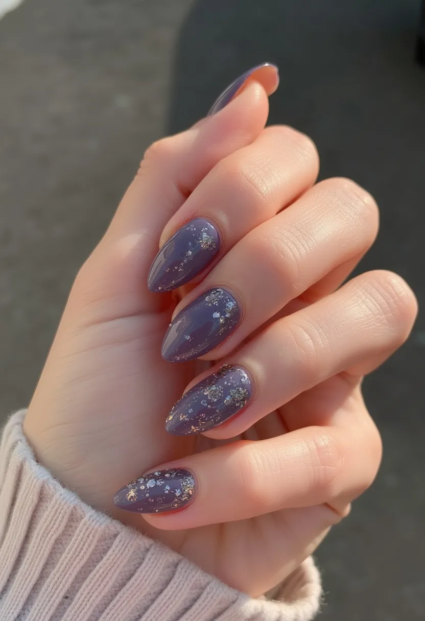 The nail design features a trendy almond shape painted in a rich, muted purple hue. The nails are embellished with delicate, glittery silver flakes scattered across the surface, adding a touch of sparkle and sophistication. This nail treatment appears to be done using gel polish, providing a glossy and durable finish. The design suggests a festive or luxurious theme, suitable for special occasions or seasonal celebrations such as winter holidays. The combination of the elegant color palette and shimmering decorations enhances the overall chic and refined appearance of the nails.