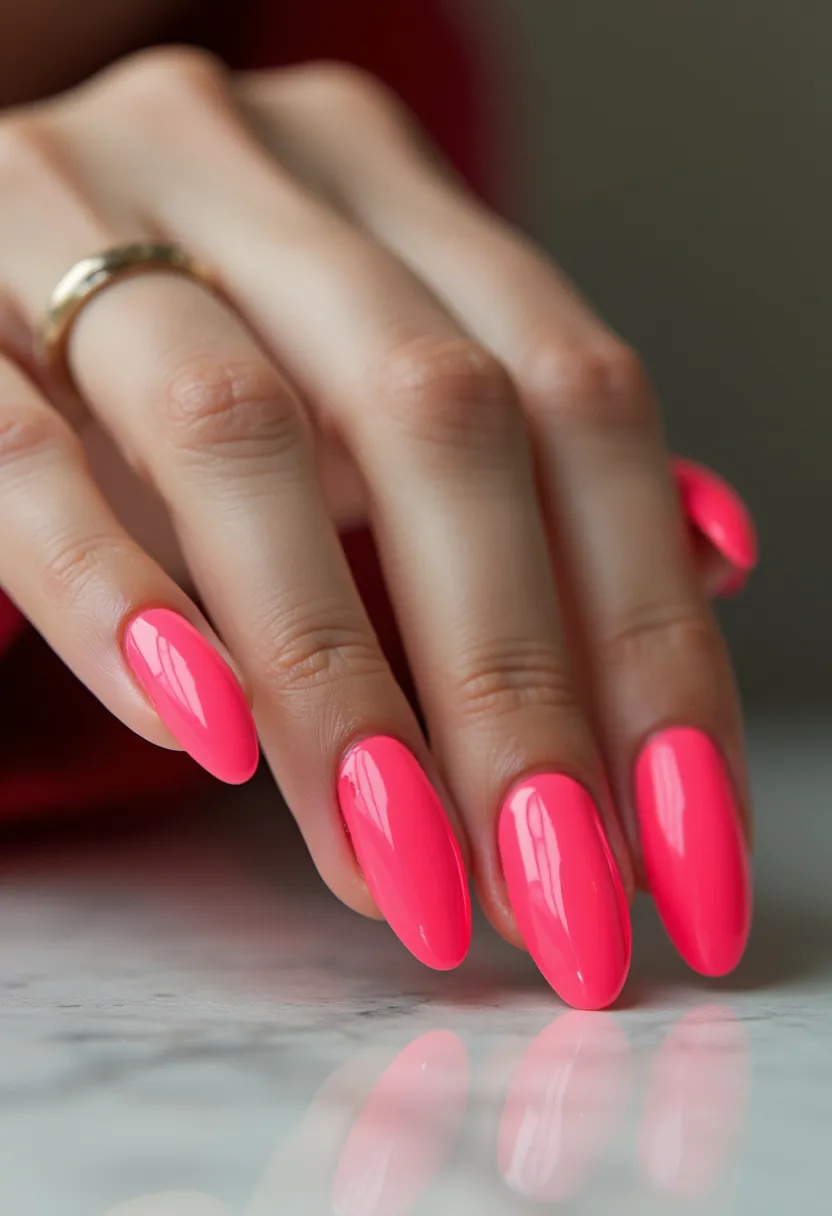 This nail design features a vibrant, neon pink color palette, which gives a bold and eye-catching look. The nails are shaped in a long almond form, which exudes elegance and sophistication. The glossy finish suggests that a gel treatment has likely been used, ensuring a smooth and shiny surface. There are no intricate patterns, decorations, or additional embellishments, allowing the bright color to stand out prominently. Overall, this design is perfect for summer or festive occasions, where a pop of vivid color can make a stylish statement.