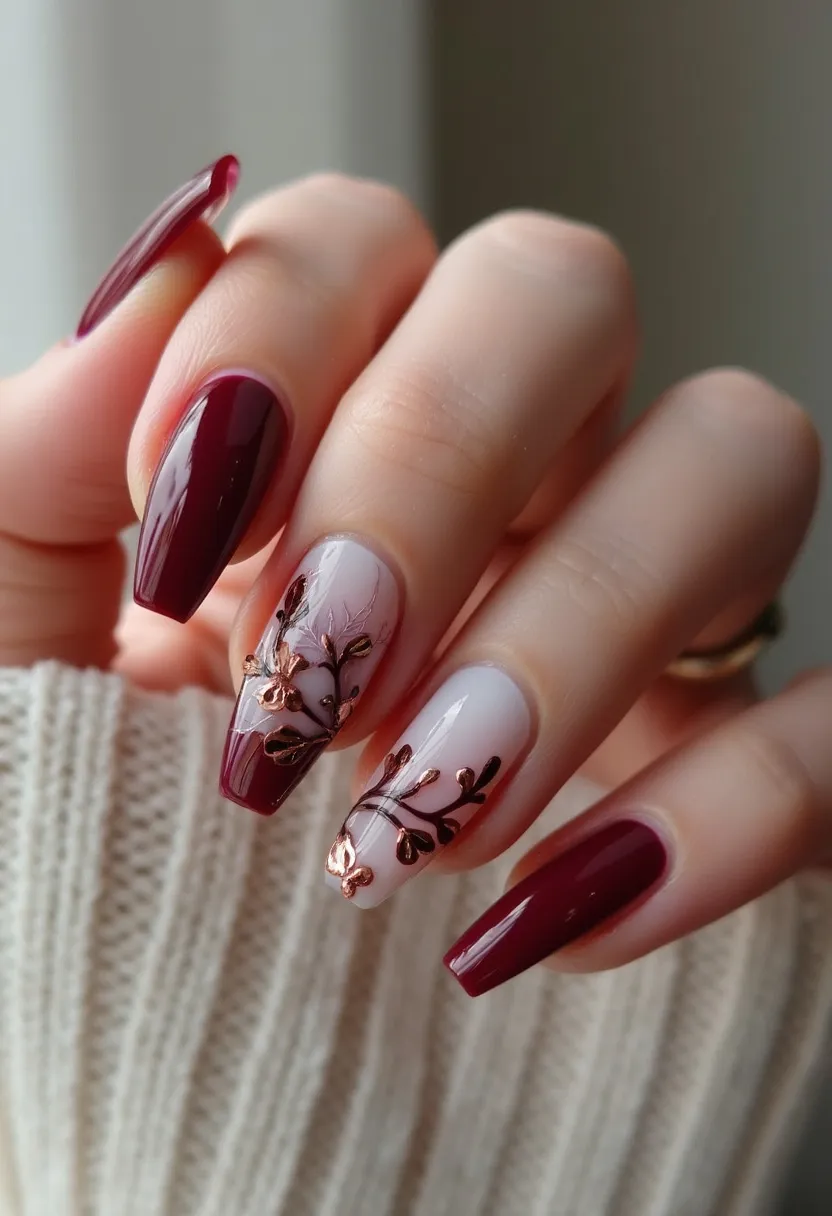 The nail design features a rich color palette consisting of deep burgundy and a soft beige shade, creating a sophisticated contrast. The nails are shaped in a medium-length coffin style, which is both trendy and elegant. The intricate patterns on the accent nails include delicate branch-like designs adorned with metallic rose gold embellishments that give a three-dimensional effect, making them stand out. The likely treatment used is gel, providing a glossy, high-shine finish which adds to the luxurious appearance of the nails. The overall design exudes a warm, autumnal vibe, making it ideal for the fall season or for a special occasion requiring a touch of elegance and sophistication.