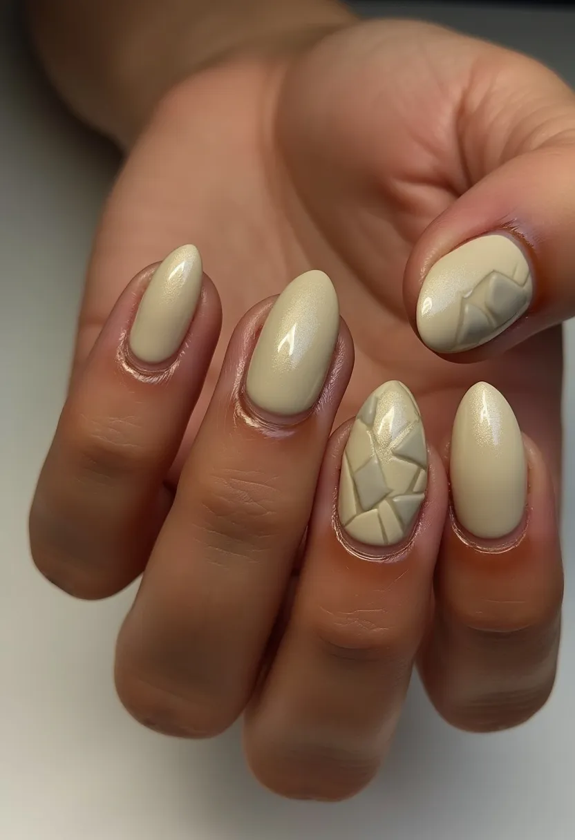 The nail design features an elegant, neutral color palette of creamy beige hues. The nails are shaped in a rounded almond style, providing a sophisticated and modern look. Two of the nails display intricate 3D patterns, resembling a mosaic or abstract quilted design, which adds a textured and dimensional element to the otherwise smooth and glossy finish. The treatment appears to be gel-based, as indicated by the high-shine and durable look of the polish. This design is versatile and suitable for any season or special occasion, providing a subtle yet artistic flair.