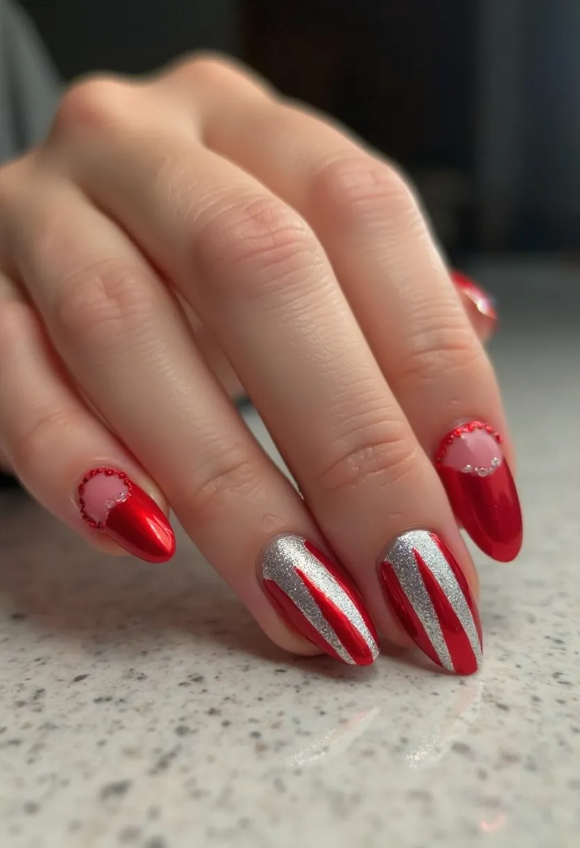 The nail design features an elegant and festive color palette of vibrant red and shimmering silver, perfectly suited for a celebratory or holiday theme. The nails are almond-shaped, providing a sophisticated canvas for the intricate patterns. The ring and index fingers showcase a bold red base with silver glitter accents in vertical stripes, adding a striking contrast. The pinky and middle fingers have a semi-transparent base adorned with delicate red beads forming semi-circular outlines, complemented by tiny crystal embellishments that enhance the design's elegance. This manicure likely uses gel or acrylic treatment for durability and a polished finish, making it ideal for special occasions such as Christmas or New Year's celebrations.