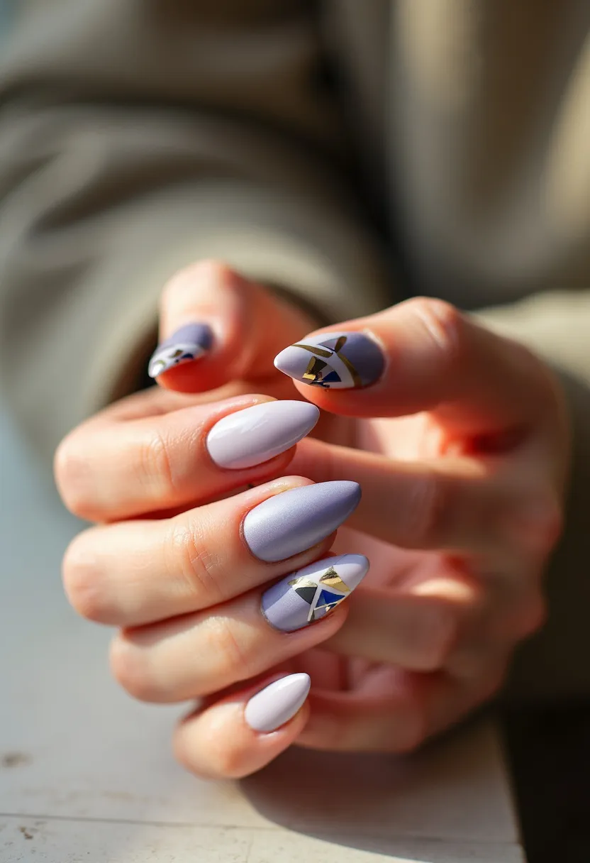 The nail design features a soft, pastel color palette dominated by shades of lavender, white, and touches of gold and blue details. The nails are oval-shaped, offering a stylish yet elegant appearance. Each nail appears to be finished with a smooth, matte texture, likely suggesting a gel or shellac treatment for durability and shine. The intricate patterns consist of abstract geometric shapes, incorporating triangles and diagonal lines in gold and blue, which add a sophisticated and artistic flair to the design. This nail art showcases a unique and contemporary look, making it suitable for a variety of occasions, from casual outings to more formal events.