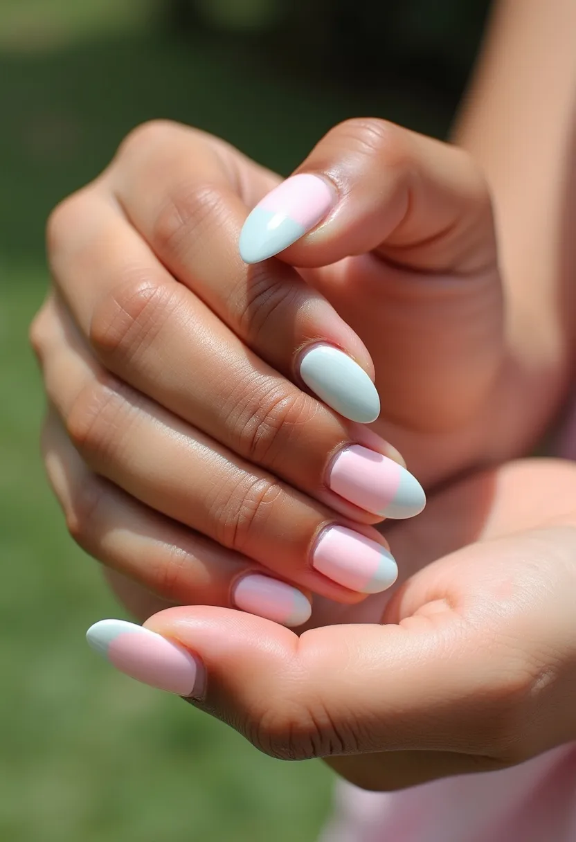 The nail design features a soft and elegant color palette with pastel pink and light mint green shades. The nails are shaped in an almond style, giving them a naturally elongated and sophisticated look. The design includes an alternating color pattern, with some nails predominantly pink and others green, and a few with a half-and-half design incorporating both colors. The surface of the nails appears smooth and glossy, indicative of a gel or shellac treatment that enhances their shine and durability. The pastel hues and clean, uncomplicated pattern suggest a fresh and springtime theme, making this design suitable for the season or for subtle, stylish occasions.