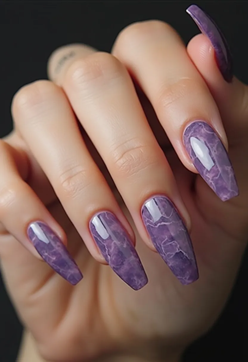 The nail design showcases a sophisticated marbled effect, primarily using a purple color palette with various shades ranging from light lavender to deep violet. The nails are long and almond-shaped, providing a sleek and elegant appearance. The intricate marbling pattern adds a depth and texture to each nail, resembling the natural veining seen in polished stones. The high-gloss finish suggests a gel or shellac treatment, adding durability and shine. This design evokes a sense of luxury and is suitable for special occasions or as a stylish statement piece for any season, especially favoring fall or winter due to its rich and cool color tones.