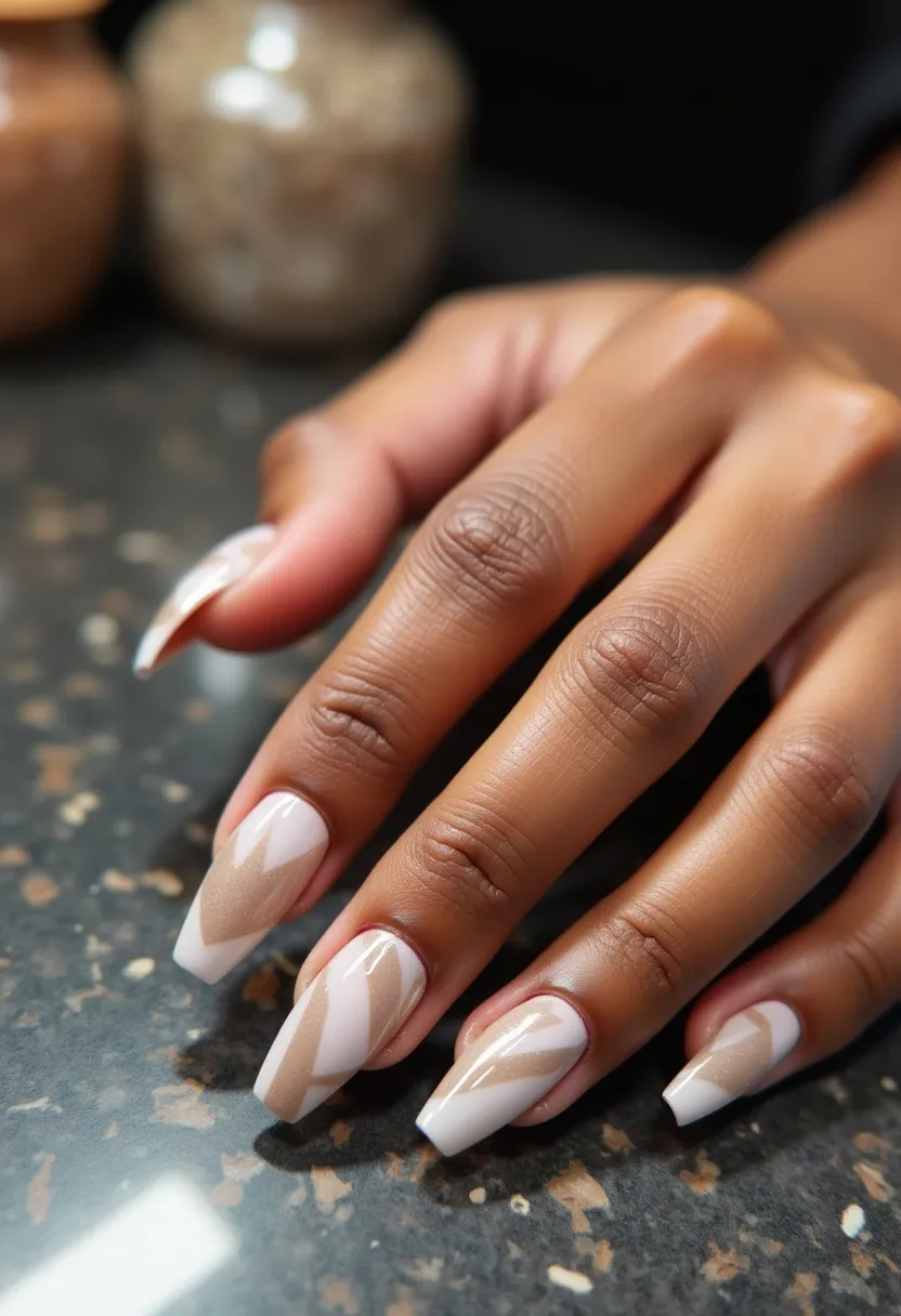 The nail design features a sophisticated color palette primarily consisting of neutral tones such as white, beige, and light brown. The nails are long and squared, exhibiting a well-maintained, sharp shape. Each nail showcases an intricate geometric pattern, incorporating diagonal and zigzag stripes that alternate between the neutral hues, creating a visually appealing contrast. The finish appears to be glossy, suggesting the use of gel treatment to achieve a smooth and shiny surface. The overall design is elegant and versatile, making it suitable for both professional settings and special occasions, such as weddings or formal events. The neutral colors and geometric patterns suggest an autumnal theme, perfect for the fall season.