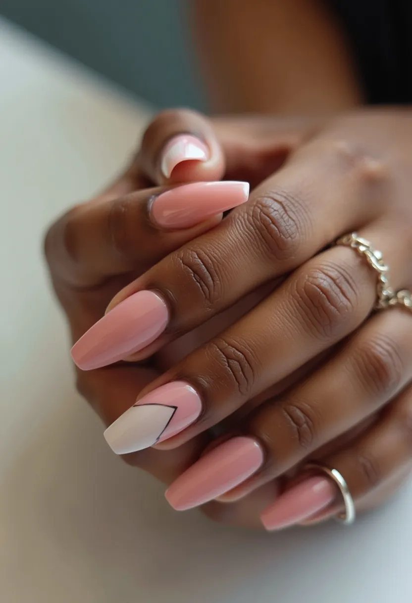 The nail design features a soft and elegant color palette consisting primarily of a pastel pink shade complemented by accents of white and some delicate black linework. The nails are shaped in a long, tapered ballerina style which provides a sophisticated and chic look. One nail stands out with a unique design, having a diagonal white section outlined in a thin black line, adding a touch of modern geometric flair to the otherwise classic manicure. The overall finish suggests a glossy, high-shine appearance typical of gel nail treatments. This design exudes a refined and polished aesthetic, making it suitable for special occasions such as weddings or formal events, while still being subtle enough for everyday wear.