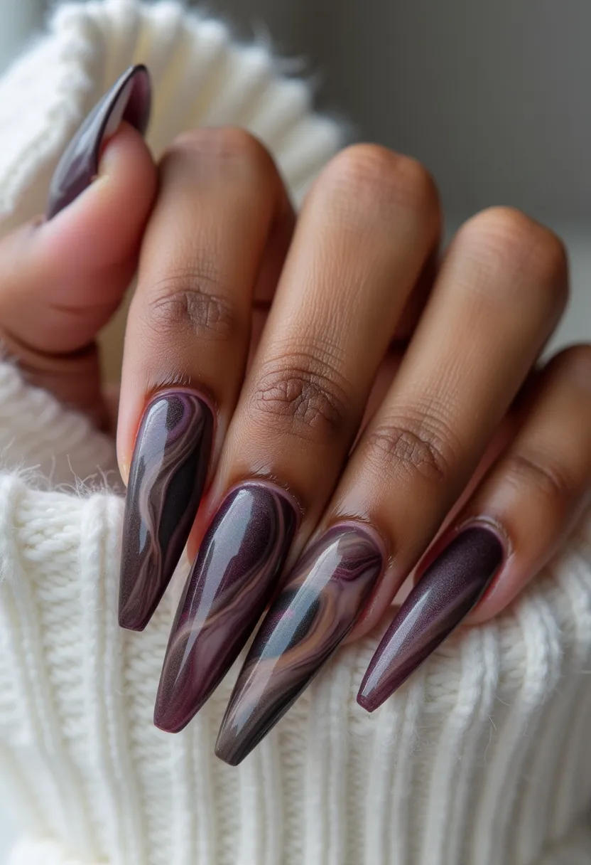 The nail design features a sophisticated palette of deep, rich purples and maroons with an intricate marbled pattern that elegantly swirls across the surfaces. The nails are long and slightly pointed, suggesting a stiletto or coffin shape. The marbling includes subtle accents of pinkish hues, giving the design a dimensional and luxurious feel. These nails appear to be treated with a glossy gel finish, adding a beautiful shine and smooth texture. This stylish and polished look could be ideal for the fall or winter seasons due to the darker color scheme, but it's versatile enough for special occasions such as evening events or celebrations.