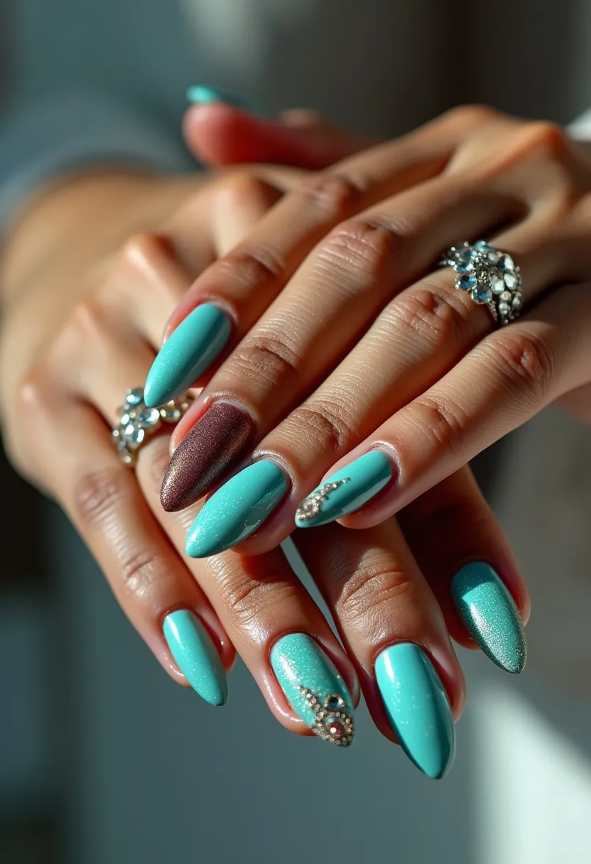 The nail design features a striking turquoise color palette with an accent nail on each hand painted in a metallic burgundy shade. The nails are almond-shaped, providing an elegant and elongating effect to the fingers. The surface has a glossy finish which suggests a gel or shellac treatment known for its long-lasting and shiny characteristics. Some nails are adorned with intricate decorations, including small rhinestones and delicate embellishments, adding a touch of glamour and sophistication. This design is versatile enough to be worn for special occasions or festive events, while the color scheme and decorative elements can make the nails suitable for spring or summer themes.